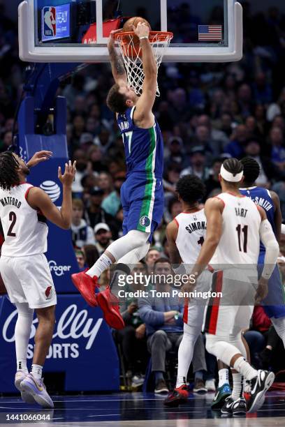 Luka Doncic of the Dallas Mavericks dunks the ball against Trendon Watford of the Portland Trail Blazers in the first half at American Airlines...