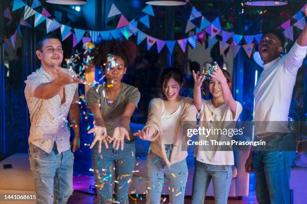 joyful group of friends celebrating new year's eve - men of the year party inside stock pictures, royalty-free photos & images