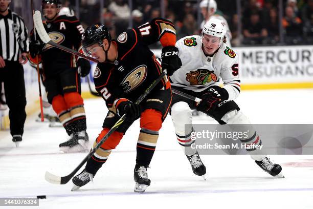 Glenn Gawdin of the Anaheim Ducks controls the puck past MacKenzie Entwistle of the Chicago Blackhawks during the first period of a game at Honda...