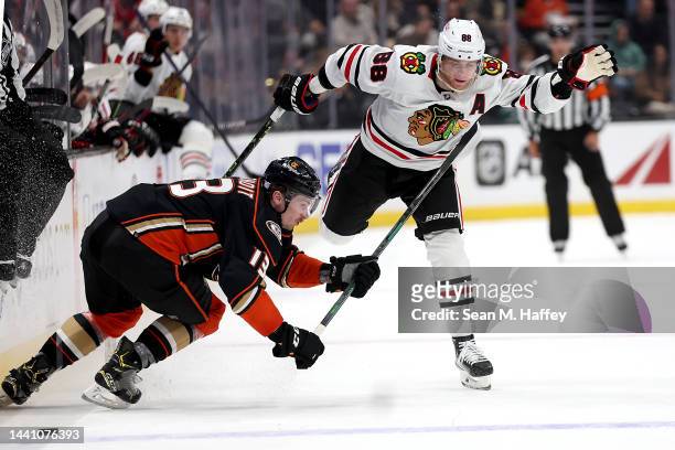 Patrick Kane of the Chicago Blackhawks avoids the check of Simon Benoit of the Anaheim Ducks during the first period of a game at Honda Center on...