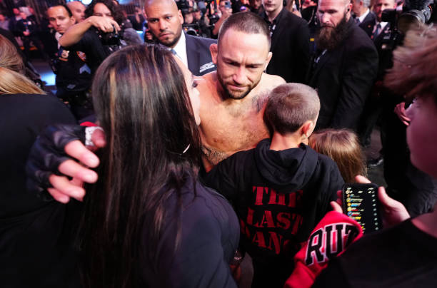 Frankie Edgar hugs his wife and kids after his loss to Chris Gutierrez in a bantamweight bout during the UFC 281 event at Madison Square Garden on...
