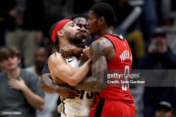 Jose Alvarado of the New Orleans Pelicans and Kevin Porter Jr. #3 of the Houston Rockets are involved in an altercation during the fourth quarter of...