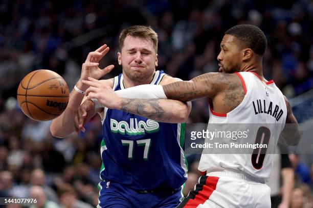 Luka Doncic of the Dallas Mavericks draws the foul against Damian Lillard of the Portland Trail Blazers in the fourth quarter at American Airlines...
