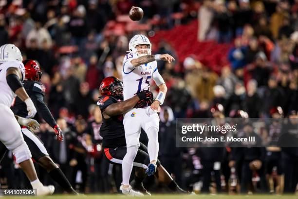 Defensive lineman Jaylon Hutchings of the Texas Tech Red Raiders hits quarterback Ethan Vasko of the Kansas Jayhawks during the second half of the...