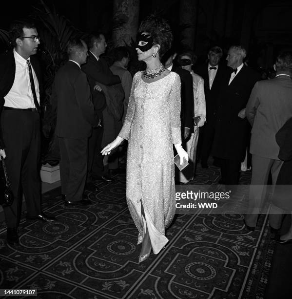 Masked Gloria Guiness arriving at Truman Capote's Black and White Ball in the Grand Ballroom at the Plaza Hotel in New York City