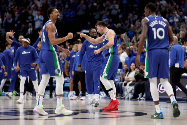Luka Doncic of the Dallas Mavericks celebrates with his team after the Dallas Mavericks beat the Portland Trail Blazers 117-112 at American Airlines...