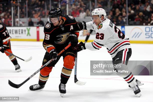 Philipp Kurashev of the Chicago Blackhawks pushes Jakob Silfverberg of the Anaheim Ducks during the second period of a game at Honda Center on...