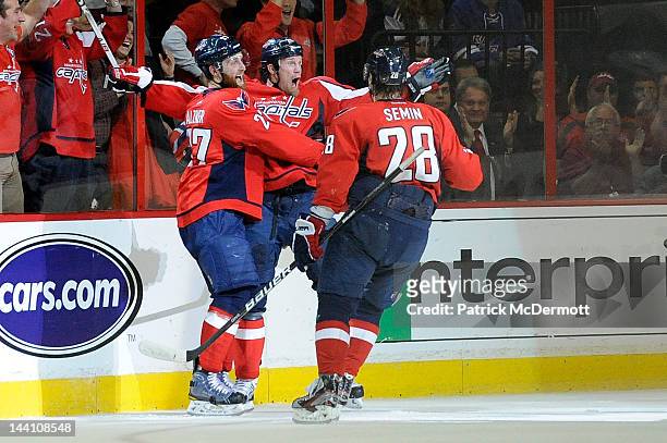 Jason Chimera celebrates with Alexander Semin and Karl Alzner of the Washington Capitals after scoring a goal against the New York Rangers in the...