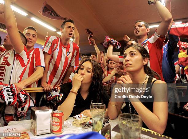 Atletico Madrid fans watch their team play Athletic Bilbao in the UEFA Europa League Final at a Madrid bar on May 9, 2012 in Madrid, Spain.