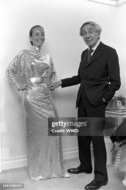Fashion designer Normal Norell with a model wearing a metallic dress from his Spring/Summer 1973 show at Bonwit Teller in New York