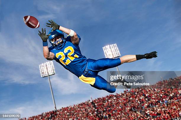 caucasian football player catching ball - american football game bildbanksfoton och bilder