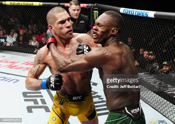 Alex Pereira of Brazil punches Israel Adesanya of Nigeria in the UFC middleweight championship bout during the UFC 281 event at Madison Square Garden...