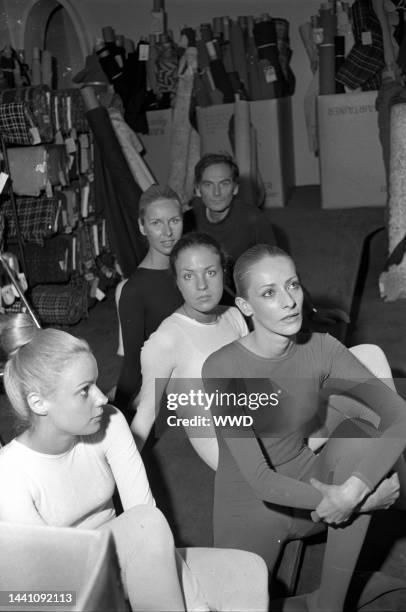 Fashion designer Pierre Cardin poses with models in the "bodystocking"at his Paris design studio.