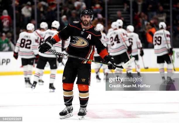 Adam Henrique of the Anaheim Ducks looks on as Chicago Blackhawks celebrate after defeating the Anaheim Ducks 3-2 in game at Honda Center on November...