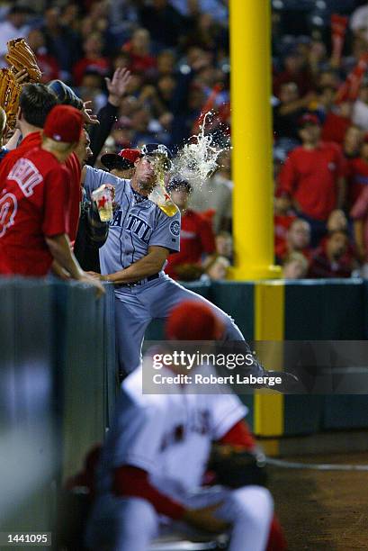 Scott Podsednik of the Seattle Mariners misses catching a foul ball in the crowd off the bat of Brad Fullmer of the Anaheim Angels in the fifth...