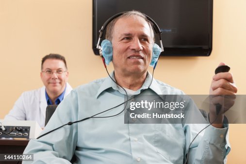 Patient using response button during audiometric evaluation Patient using response button during audiometric evaluation
