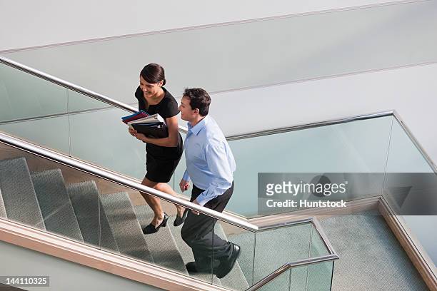 business couple talking on stairs of office building - 2 steps stock-fotos und bilder