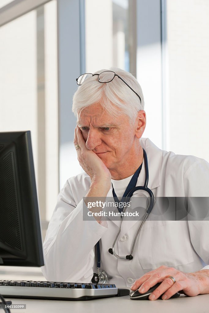 Doctor Crying Over Computer Doctor Looking Confused At His Computer High-Res Stock Photo - Getty Images
