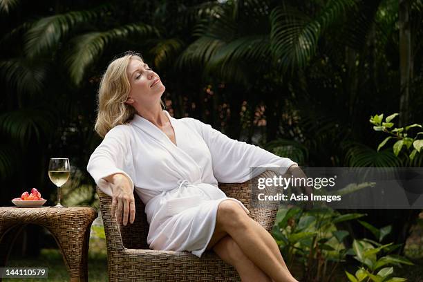 woman sitting outside in robe, glass of wine - wine spa stock pictures, royalty-free photos & images