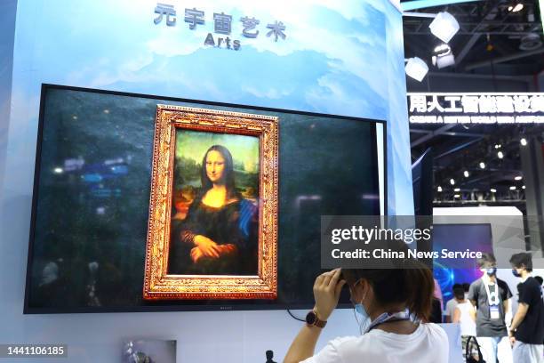 Woman views Metaverse painting of Mona Lisa at an expo of the 2022 World Conference on VR Industry on November 12, 2022 in Nanchang, Jiangxi Province...