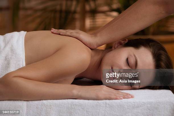 young woman having massage - energy healing stock pictures, royalty-free photos & images