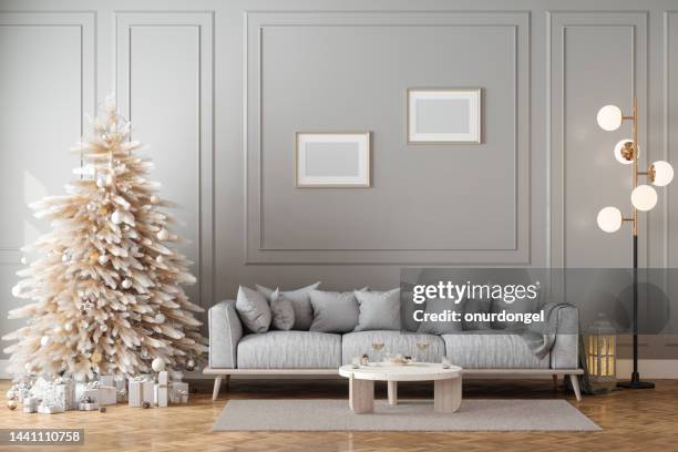 modern living room interior with christmas tree, gift boxes, sofa and empty frames - minimal christmas stock pictures, royalty-free photos & images