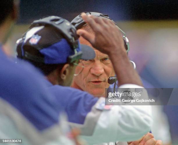 Head coach Barry Switzer of the Dallas Cowboys talks to an assistant coach on the sideline during a game against the Pittsburgh Steelers at Three...