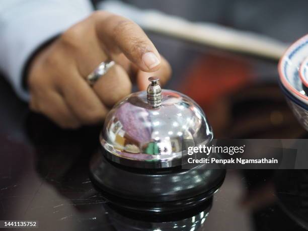 index finger push ringing bell on table - hand bell stock pictures, royalty-free photos & images