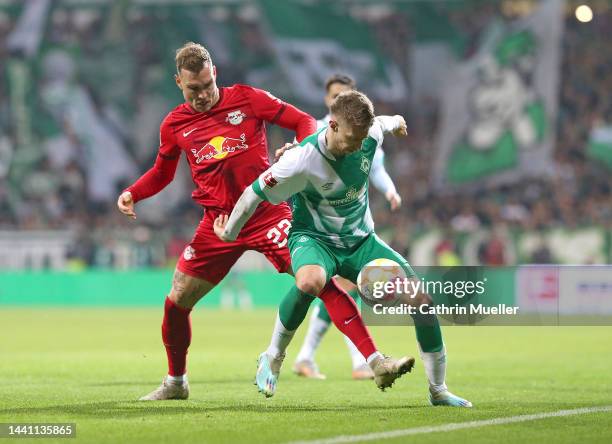 Mitchell Weiser of Werder Bremen is challenged by David Raum of RB Leipzig during the Bundesliga match between SV Werder Bremen and RB Leipzig at...