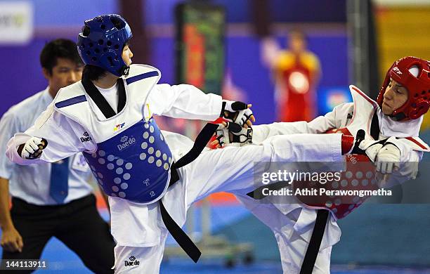 Mayu Hamada of Japan in action against Raheleh Asemani of Iran during day two of the 20th Asian Taekwondo Championships at Phu Tho Stadium on May 10,...