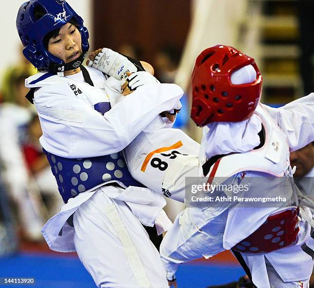 Mayu Hamada of Japan in action against Raheleh Asemani of Iran during day two of the 20th Asian Taekwondo Championships at Phu Tho Stadium on May 10,...