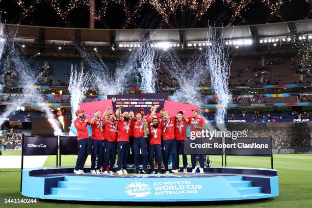 Jos Buttler of England and teammates celebrate victory with the T20 World Cup trophy following the ICC Men's T20 World Cup Final match between...