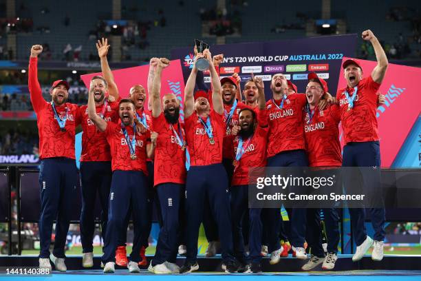 Jos Buttler of England and teammates celebrate victory with the T20 World Cup trophy following the ICC Men's T20 World Cup Final match between...