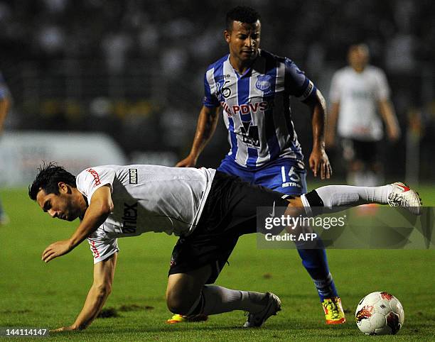 Douglas of Brazil´s Corinthians, vies for the ball with Oscar Bagui of Ecuador´s Emelec, during their 2012 Copa Libertadores football match held at...