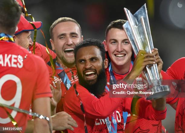 Adil Rashid and his English team mates celebrate with the ICC Men's T20 World Cup Trophy after winning the ICC Men's T20 World Cup Final match...