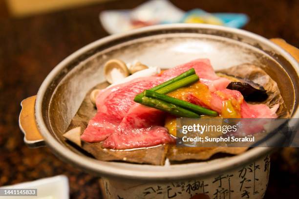 a dish with slices of hida beef with miso served on stove to cook, gifu, japan - gifu prefecture stock pictures, royalty-free photos & images