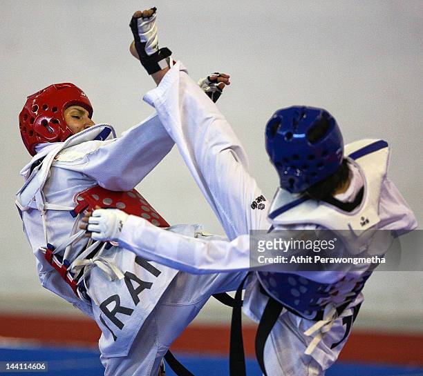 Mayu Hamada of Japan in action against Raheleh Asemani of Iran during day two of the 20th Asian Taekwondo Championships at Phu Tho Stadium on May 10,...