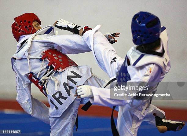 Mayu Hamada of Japan in action against Raheleh Asemani of Iran during day two of the 20th Asian Taekwondo Championships at Phu Tho Stadium on May 10,...