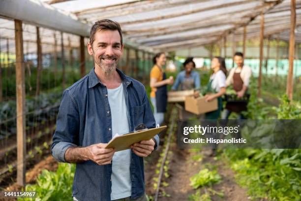 happy man managing an organic farm - country market stock pictures, royalty-free photos & images