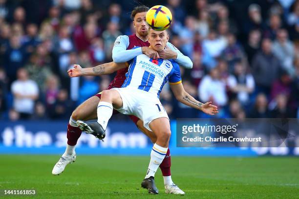 Leandro Trossard of Brighton & Hove Albion is challenged by Matty Cash of Aston Villa during the Premier League match between Brighton & Hove Albion...