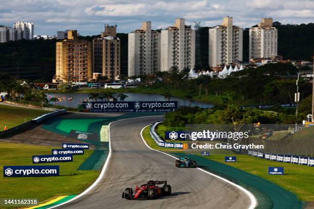 Carlos Sainz of Spain driving the Ferrari F1-75 leads Lewis Hamilton of Great Britain driving the Mercedes AMG Petronas F1 Team W13 during the Sprint...