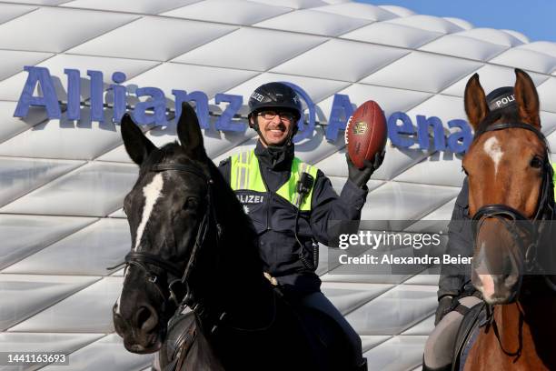 German mounted police officer holds up a American football in front of the Allianz Arena stadium before the NFL match between Seattle Seahawks and...