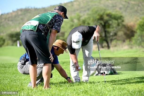 Ryan Fox of New Zealand and referee check the ball position on the 15th hole during Day Four of the Nedbank Golf Challenge at Gary Player CC on...