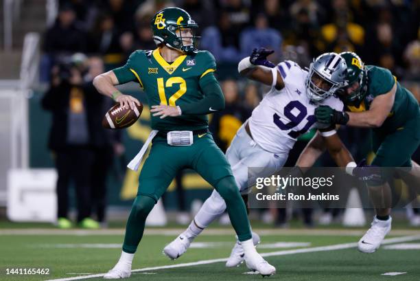 Blake Shapen of the Baylor Bears throws under pressure from Felix Anudike-Uzomah of the Kansas State Wildcats in the first half at McLane Stadium on...