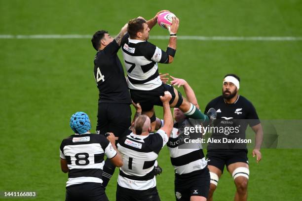 Luke Whitelock of Barbarians catches a high ball under pressure from Bryce Heem of New Zealand during the Killik Cup match between Barbarians and New...
