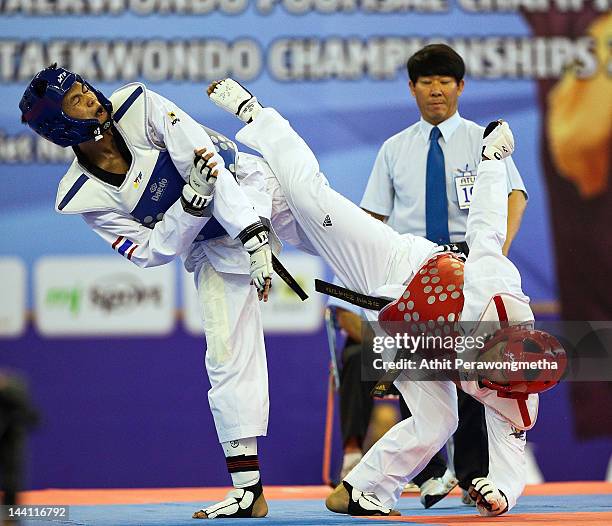 Raja Zulfadli Bin Raja Mah of Singapore in action against Peerathep Sila-on of Thailand during day two of the 20th Asian Taekwondo Championships at...