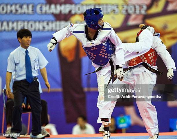 Raja Zulfadli Bin Raja Mah of Singapore in action against Peerathep Sila-on of Thailand during day two of the 20th Asian Taekwondo Championships at...