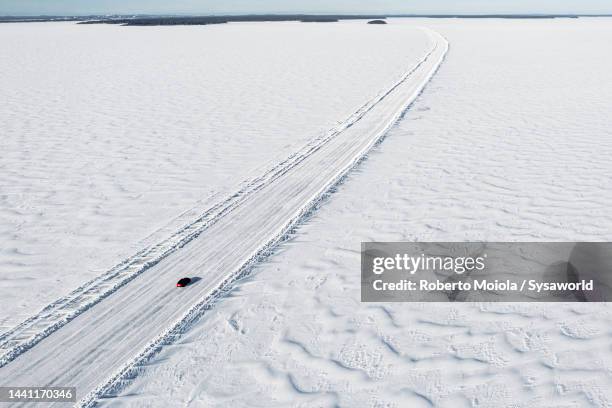 car driving on slippery ice road on the frozen sea - lulea - fotografias e filmes do acervo