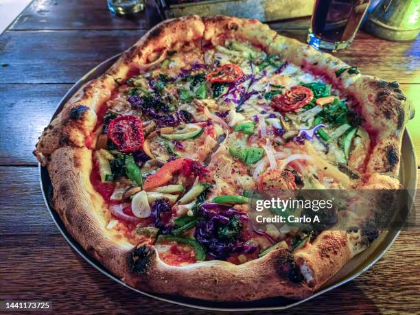 vegetarian pizza served at restaurant - vegetarian pizza stock pictures, royalty-free photos & images