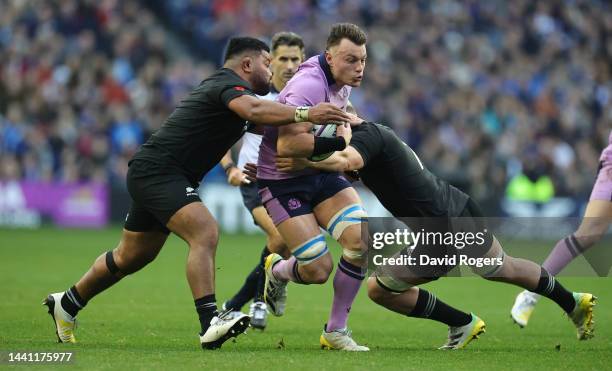 Jack Dempsey of Scotland is tackled by Samisoni Taukei'aho and Dalton Papali'i during the Autumn International match between Scotland and New Zealand...